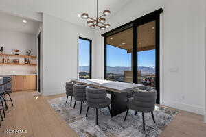 Dining room with an inviting chandelier and light hardwood / wood-style floors