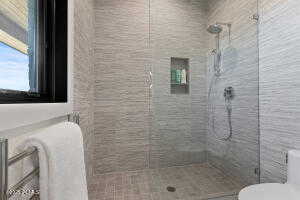 Bathroom featuring toilet and tiled shower