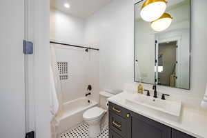 Full bathroom featuring vanity, shower / bathtub combination, and toilet