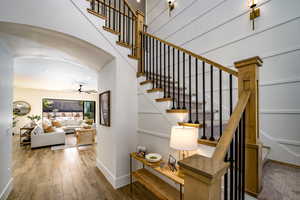 Stairs featuring wood-type flooring and ceiling fan