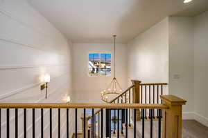 Details featuring carpet floors and a notable chandelier