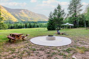 View of yard featuring a mountain view and an outdoor fire pit