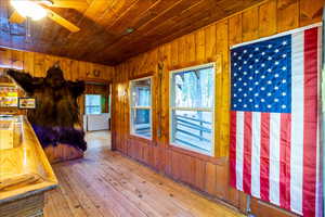 Interior space featuring wood walls, wooden ceiling, and hardwood / wood-style flooring