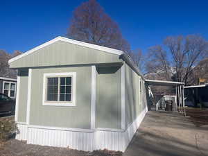 View of property exterior featuring a carport