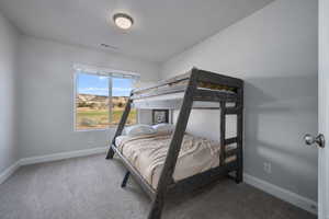 Bedroom featuring carpet flooring and a textured ceiling