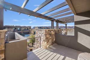 Balcony featuring a mountain view and a pergola