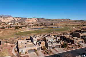 Birds eye view of property with a water and mountain view