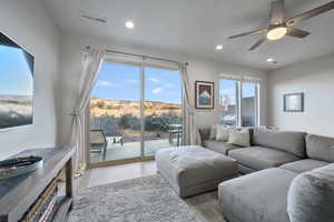 Living room featuring ceiling fan, a mountain view, and light hardwood / wood-style flooring