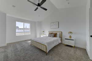 Carpeted bedroom featuring ceiling fan and lofted ceiling