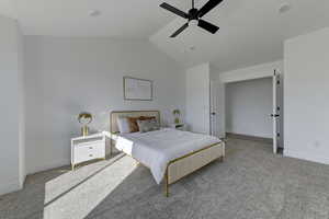 Bedroom featuring light carpet, vaulted ceiling, and ceiling fan