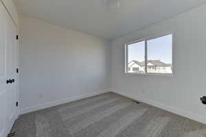 Spare room featuring carpet flooring