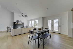 Dining room featuring light hardwood / wood-style floors, lofted ceiling, and ceiling fan