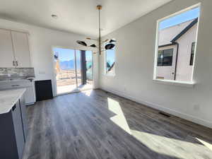 Unfurnished dining area with plenty of natural light, baseboards, visible vents, and a mountain view