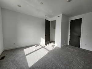Unfurnished bedroom with visible vents and carpet floors