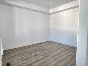 Spacious main floor office or music room with high ceilings, large windows and laminate flooring.