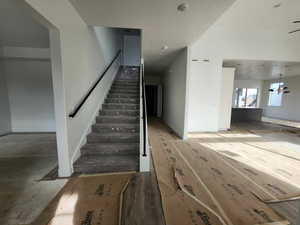 Stairway with baseboards and wood finished floors