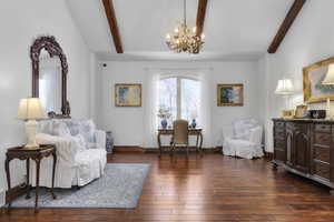 Living area with beam ceiling and an inviting chandelier