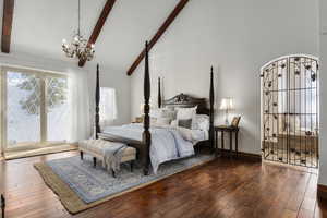 Bedroom featuring a chandelier, high vaulted ceiling, and beam ceiling