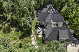 Aerial view of property and surrounding area with a heavily wooded area
