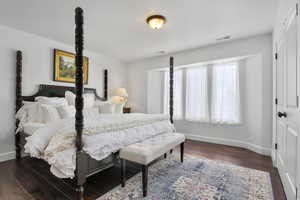 Bedroom with dark wood-type flooring