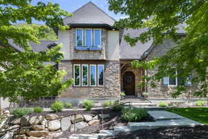 View of front of home with stone siding and stucco siding