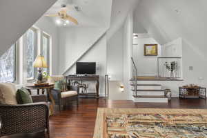 Interior space featuring vaulted ceiling, ceiling fan, and dark hardwood / wood-style flooring