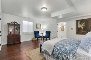 Bedroom with dark hardwood / wood-style floors