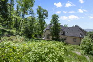 View of home's exterior featuring stucco siding and a chimney