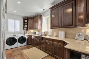 Laundry room with sink and washer and clothes dryer