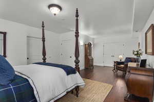 Bedroom with dark hardwood / wood-style floors