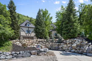 View of front facade featuring stucco siding and stone siding