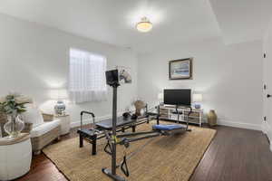 Exercise room with dark wood-type flooring