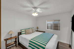 Bedroom with hardwood / wood-style floors and ceiling fan