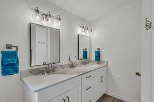 Bathroom featuring vanity and wood-type flooring