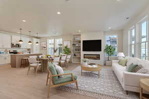 Living room featuring light wood finished floors, visible vents, and recessed lighting. Virtual Staged