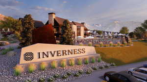 Community sign featuring a mountain view and a lawn