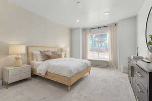 Bedroom with light colored carpet