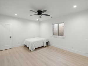 Bedroom featuring ceiling fan and light hardwood / wood-style flooring