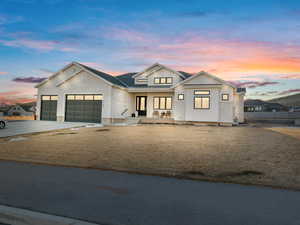 Modern farmhouse style home with a yard, a garage, and a porch