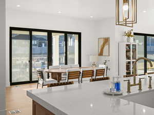 Dining area featuring sink and light hardwood / wood-style flooring