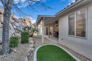 View of yard with ceiling fan and a patio