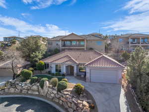 Mediterranean / spanish home featuring a garage