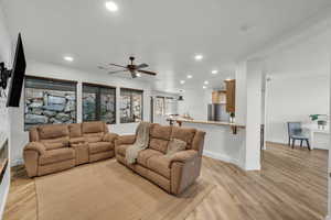 Living room featuring light wood-type flooring and ceiling fan