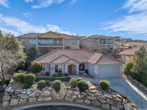 Mediterranean / spanish home featuring a garage