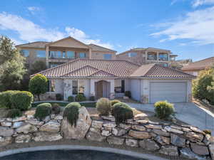 Mediterranean / spanish-style house with a balcony and a garage