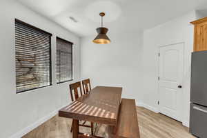 Dining area with light wood-type flooring