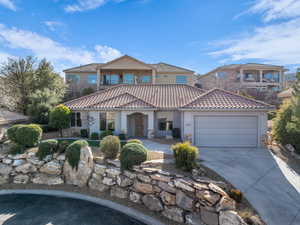 Mediterranean / spanish home featuring a garage