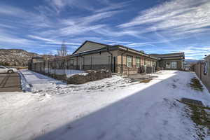 View of snowy exterior with central AC unit and a mountain view