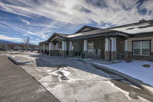 View of snow covered exterior featuring a porch