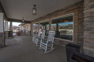 Snow covered patio featuring covered porch and a mountain view